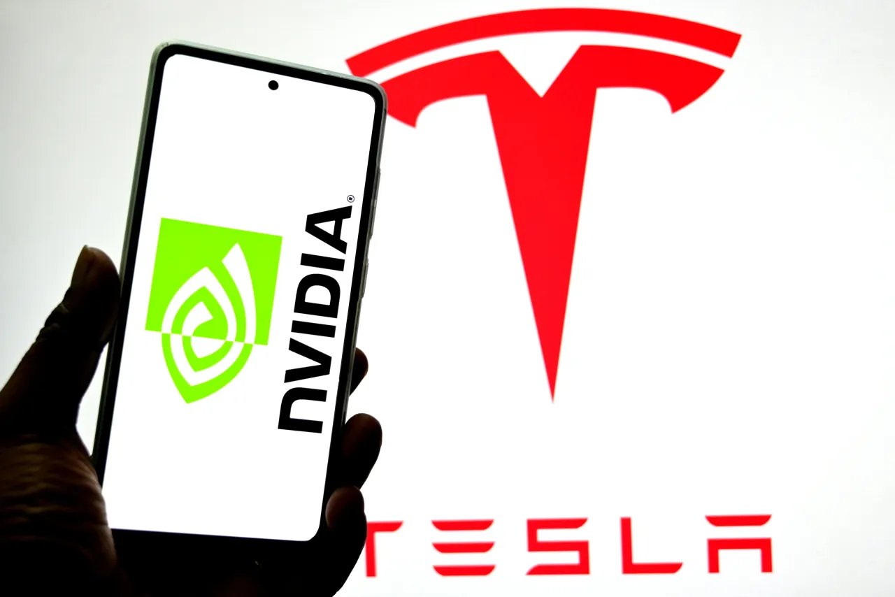 In this photo illustration, a Nvidia logo is seen displayed on a smartphone with a Tesla logo in the background. (Photo Illustration by Avishek Das/SOPA Images/LightRocket via Getty Images)
