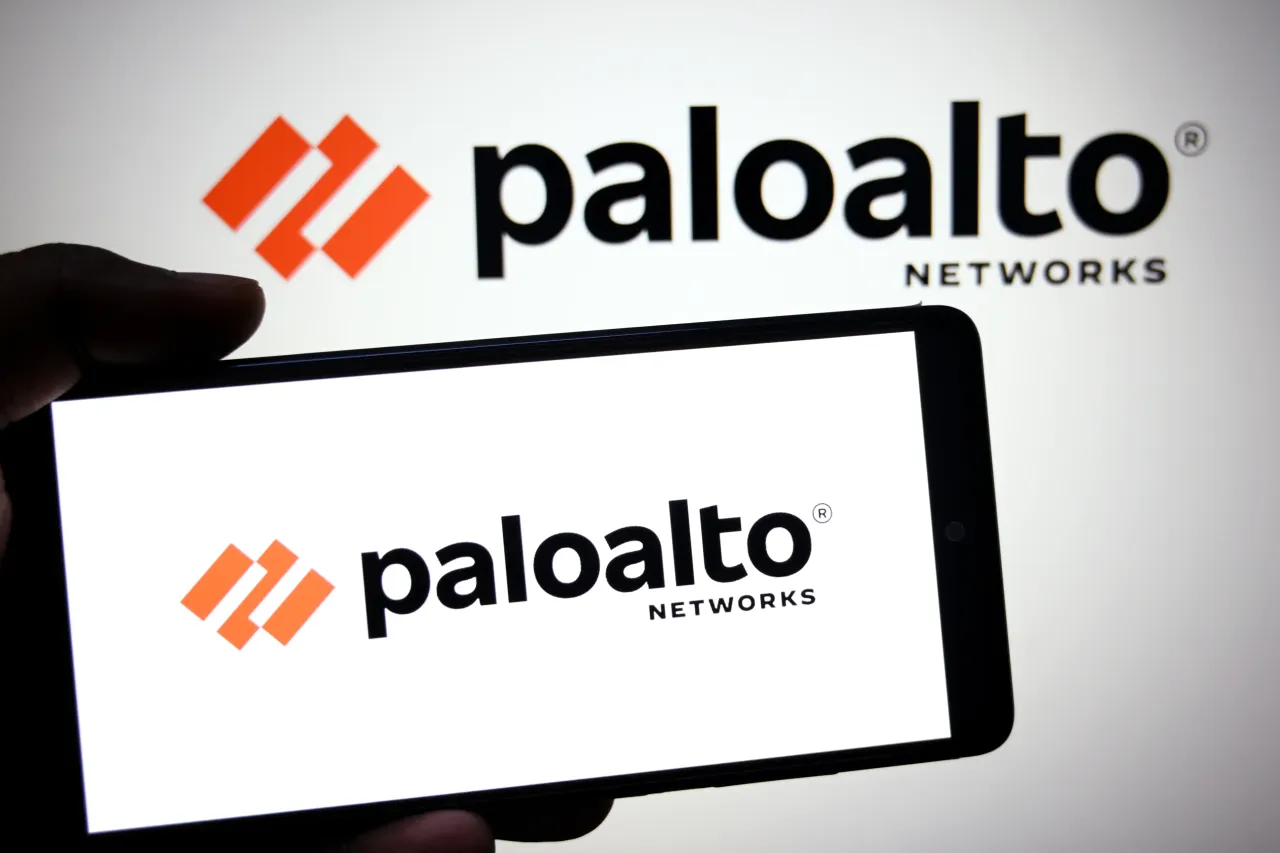 In this photo illustration, a Palo Alto Networks logo is seen displayed on a smartphone and in the background. 