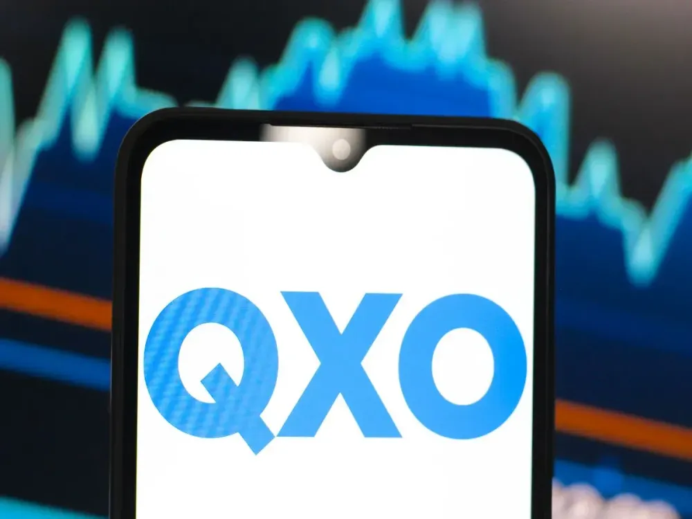  In this photo illustration, the QXO logo is seen displayed on a smartphone screen. 