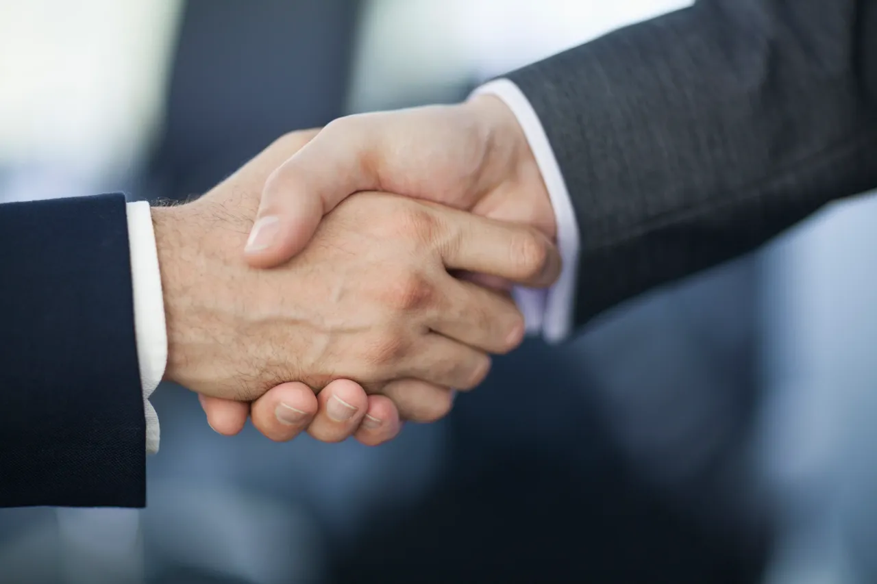 Handshake in business office (Representative stock photo courtesy of Shannon Fagan via Getty Images)