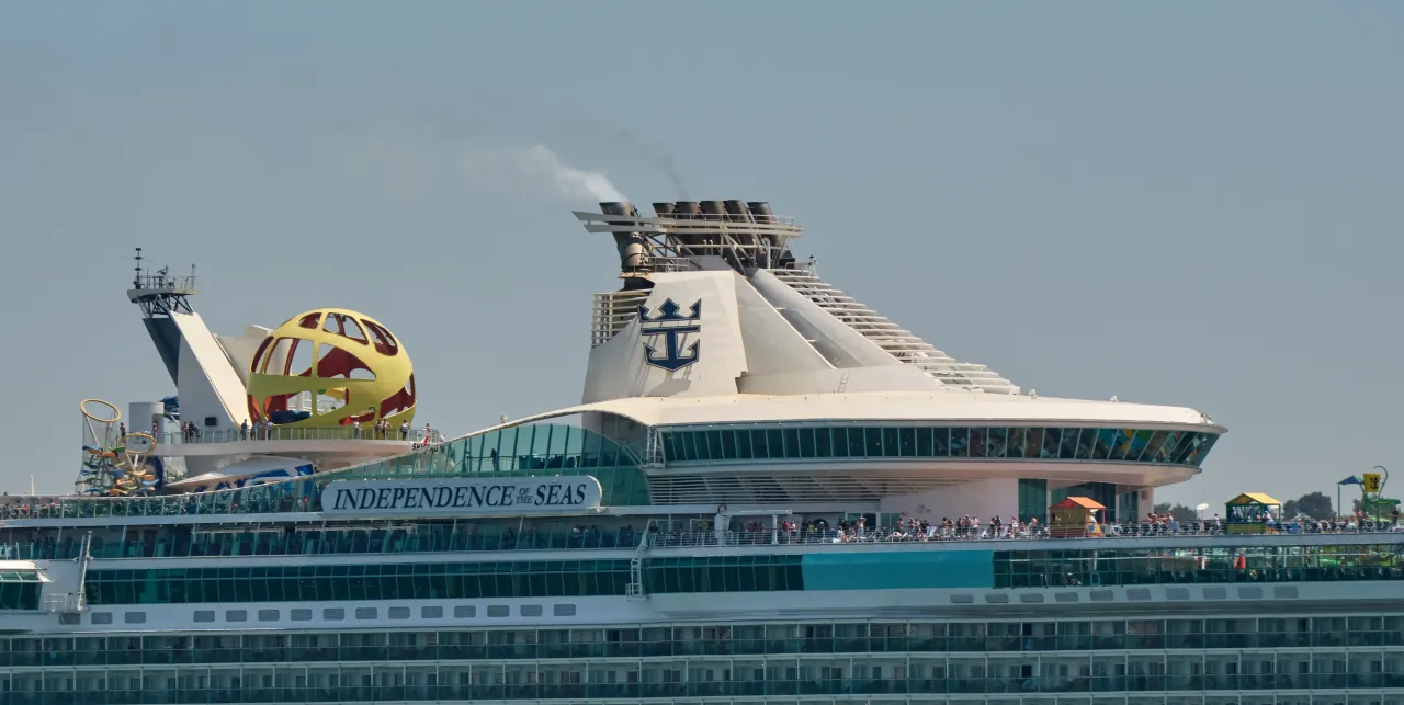Passengers are seen crowding the upper deck as MS Independence of the Seas sails the Tagus River on May 28, 2025, in Lisbon, Portugal.
