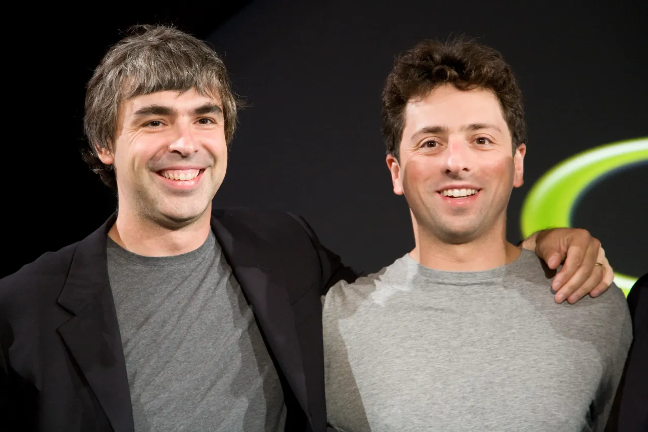 Larry Page (L) and Sergey Brin (R), the co-founders of Google, at a press event where Google and T-Mobile announced the first Android powered cellphone, the T-Mobile G1. 
