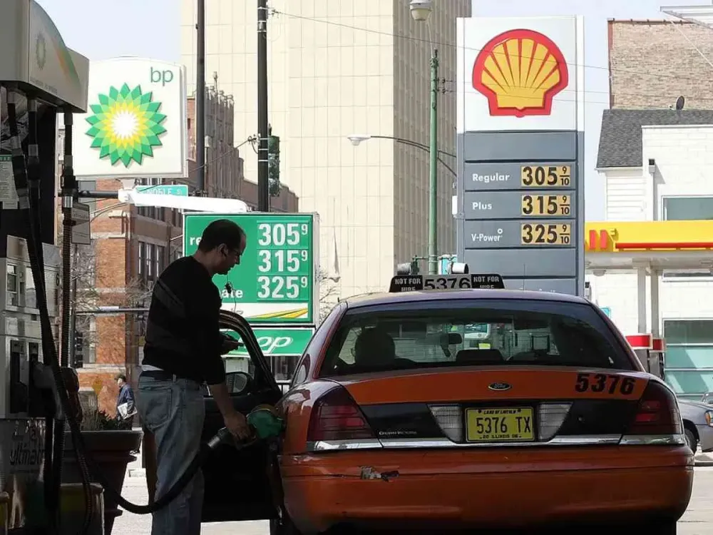  A cab driver pumps gas into his taxi at a BP Amoco station, next to a Shell station, April 18, 2006 in Chicago, Illinois. World oil prices hit a record high price today, over $71 a barrel. (Photo by Tim Boyle/Getty Images)