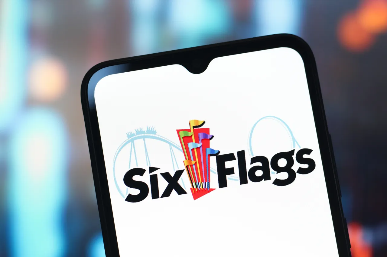  In this photo illustration, the Six Flags Entertainment logo is seen displayed on a smartphone screen. 