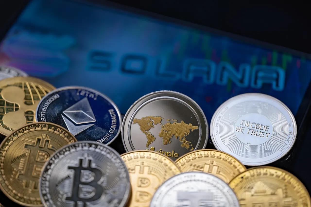 Solana logo displayed on mobile with representation of cryptocurrencies coins seen in this photo illustration, on 15 January 2023, in Brussels, Belgium.