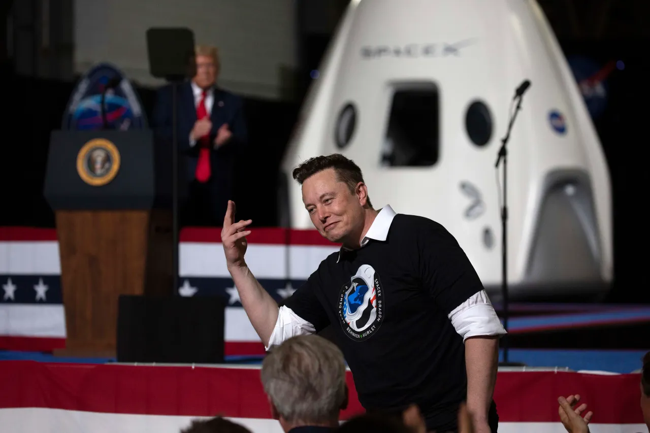 .S. President Donald Trump acknowledges SpaceX founder Elon Musk (R) after the successful launch of the SpaceX Falcon 9 rocket with the manned Crew Dragon spacecraft at the Kennedy Space Center on May 30, 2020.