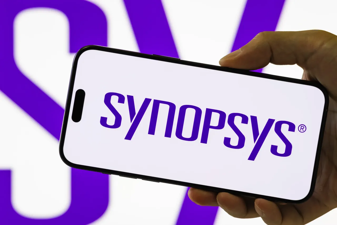 In this photo illustration, a smartphone held in a hand shows the logo of Synopsys Inc, on September 4, 2025, in Chongqing, China. 