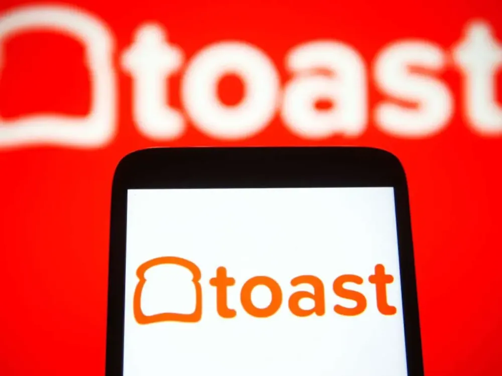 In this photo illustration a Toast Inc. logo is seen on a smartphone and a pc screen. (Photo Illustration by Pavlo Gonchar/SOPA Images/LightRocket via Getty Images)