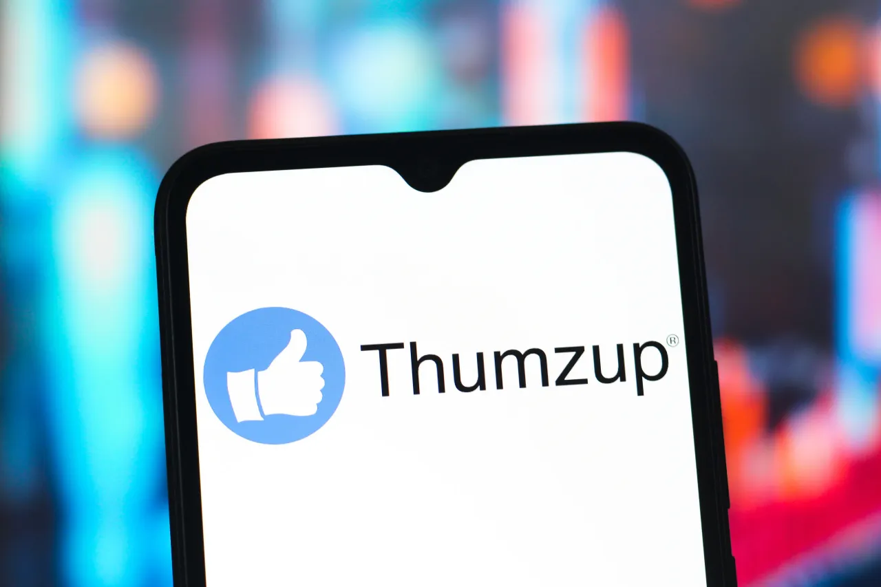 In this photo illustration, the Thumzup Media Corporation logo is seen displayed on a smartphone screen. 