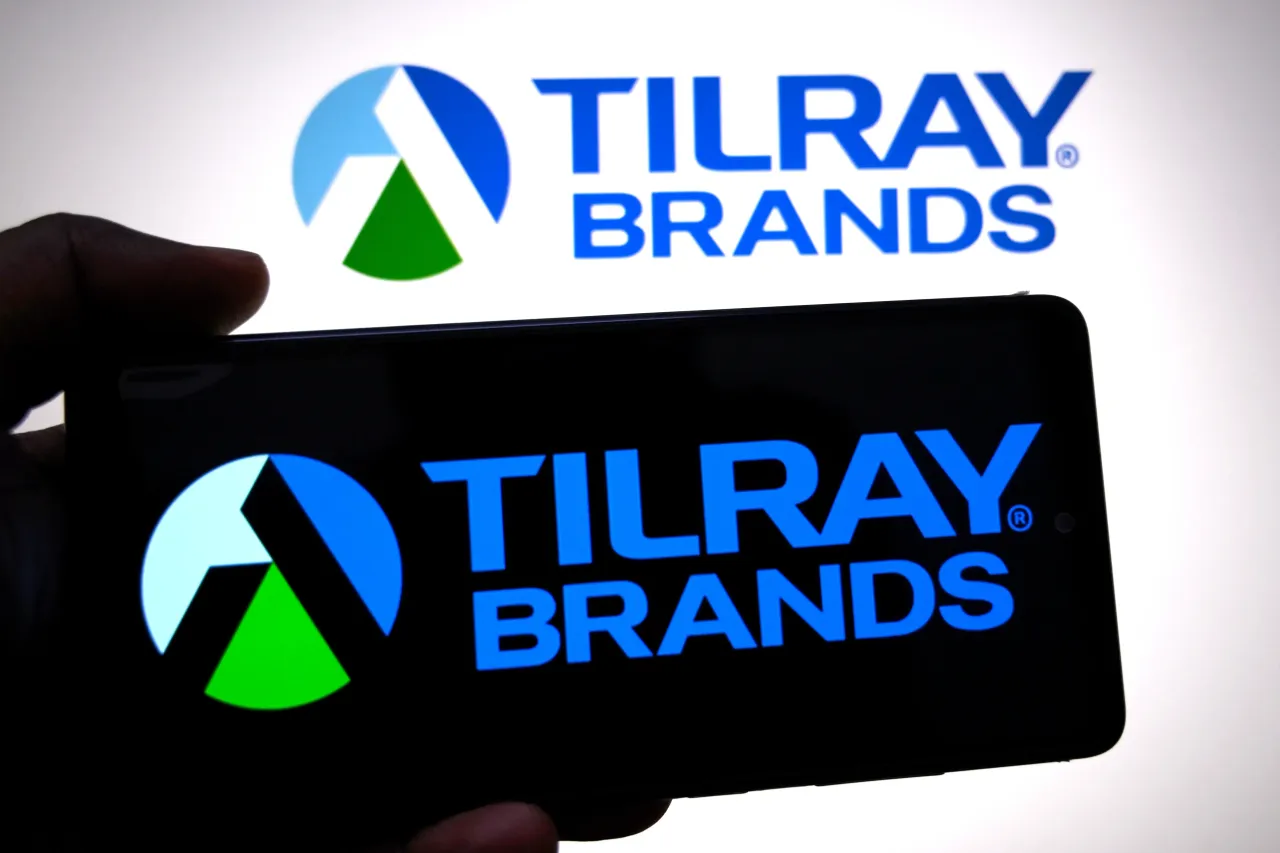In this photo illustration, a Tilray Brands logo is seen displayed on a smartphone and in the background.