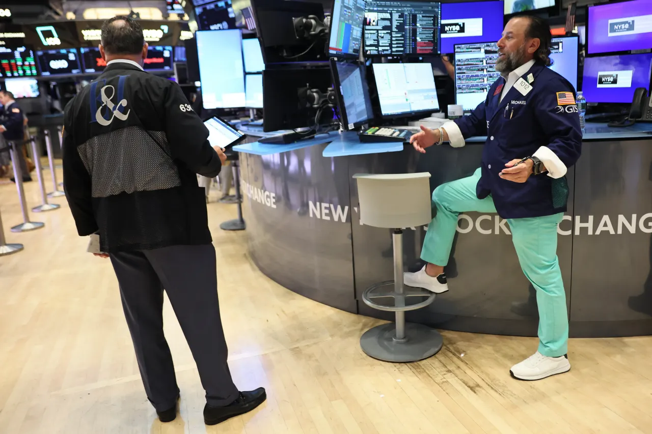 Traders work on the floor of the New York Stock Exchange during morning trading on August 22, 2025, in New York City. 