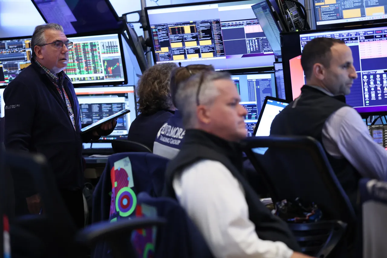 Traders work on the floor of the New York Stock Exchange during morning trading on August 26, 2025, in New York City. 