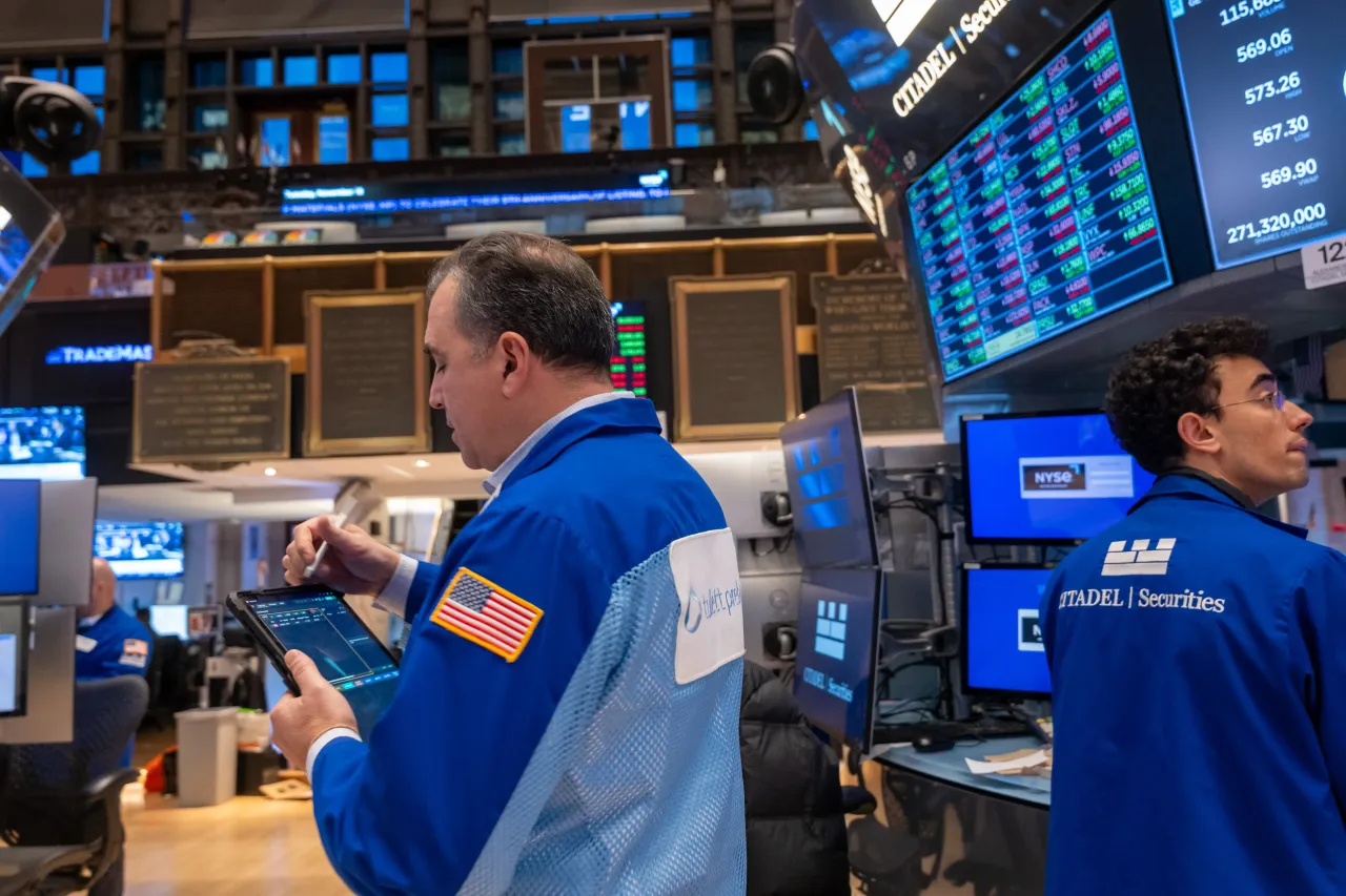 Traders work as the market opens on the floor of the New York Stock Exchange (NYSE) on November 18, 2025, in New York City. 