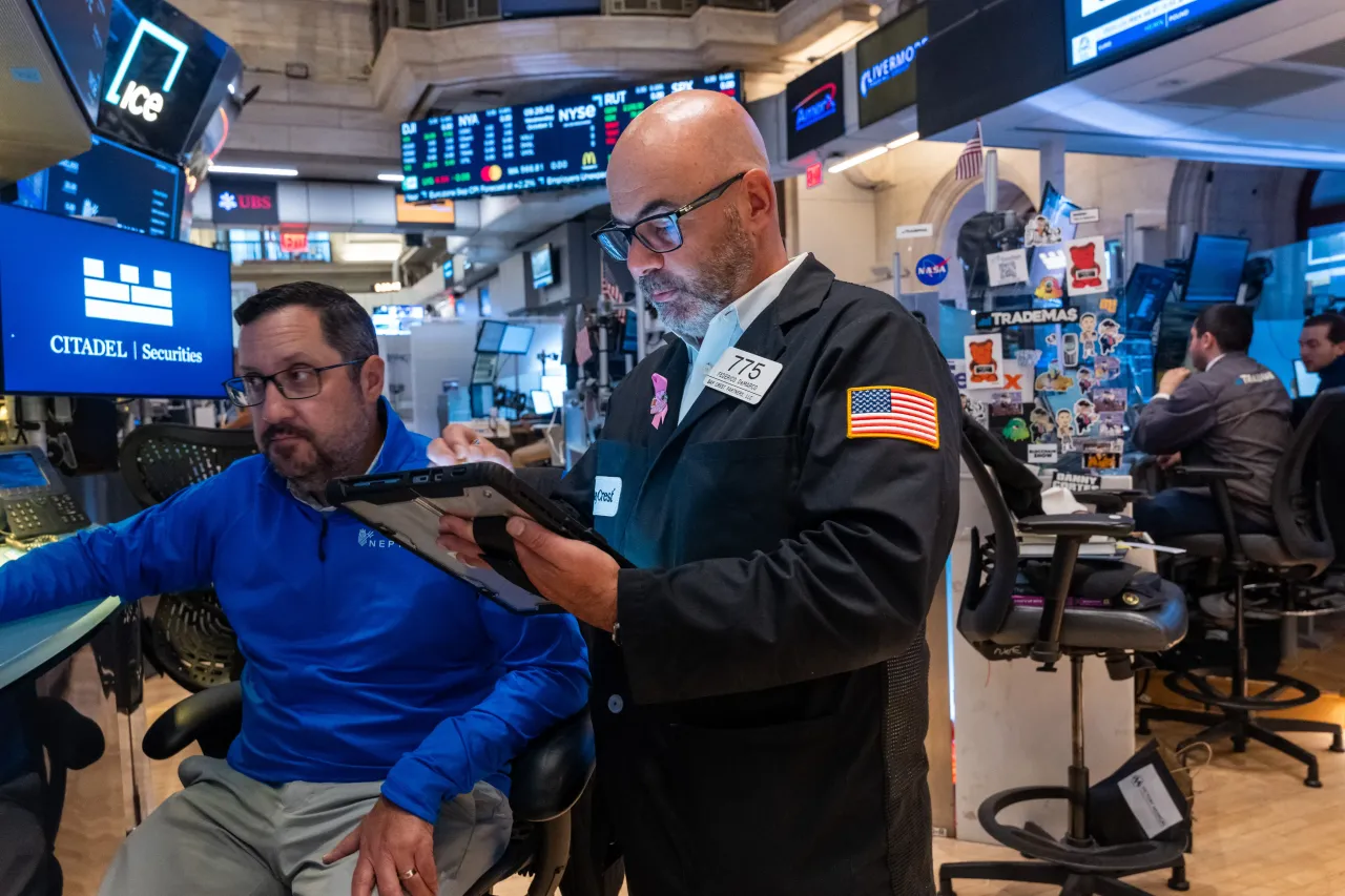 Traders work on the floor of the New York Stock Exchange (NYSE) on October 01, 2025, in New York City.  