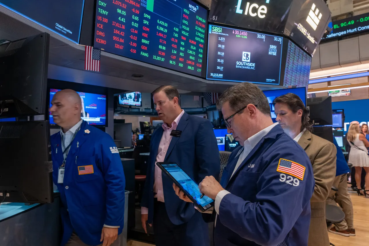Traders work on the floor of the New York Stock Exchange (NYSE) on July 28, 2025 in New York City.  