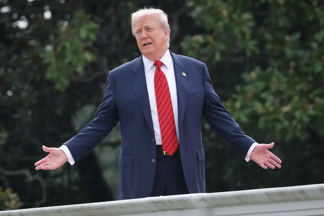  U.S. President Donald Trump gestures while answering questions from reporters as he tours the roof of the West Wing of the White House on August 05, 2025, in Washington, DC.
