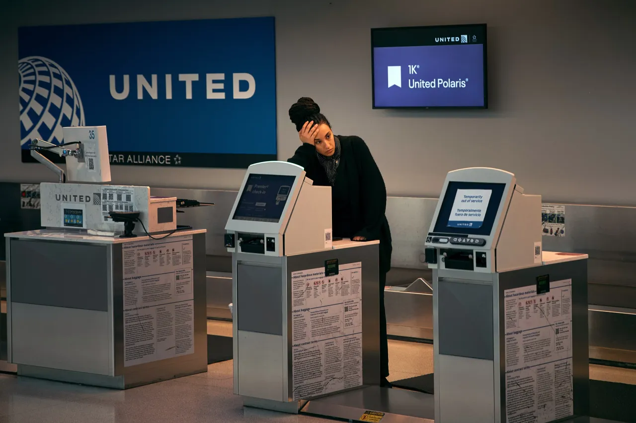 An employee stands at the United Airlines check-in area at Terminal C of Newark Liberty International Airpor on May 6, 2025 in Newark, New Jersey. 