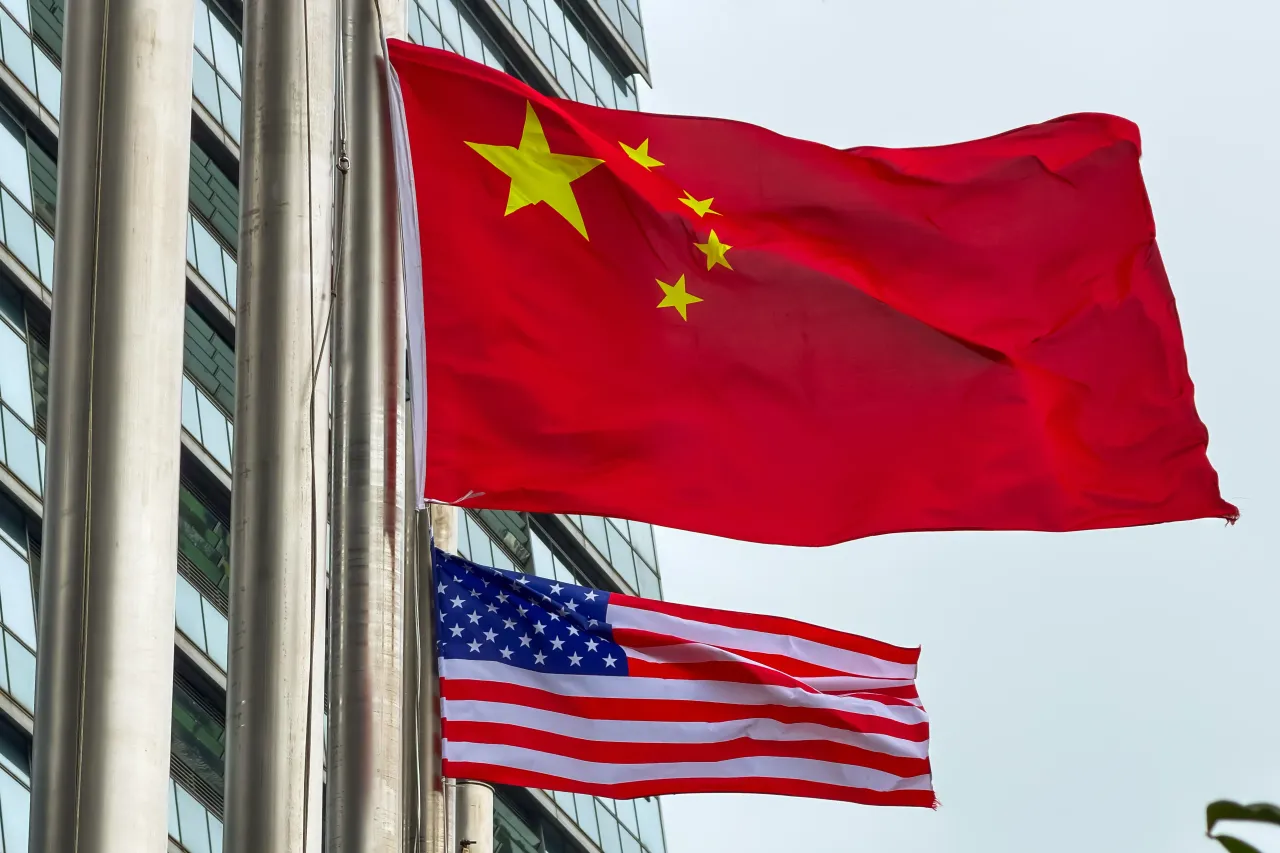 The national flags of China and the United States are seen flying outside a commercial building on March 17, 2026 in Hong Kong, China