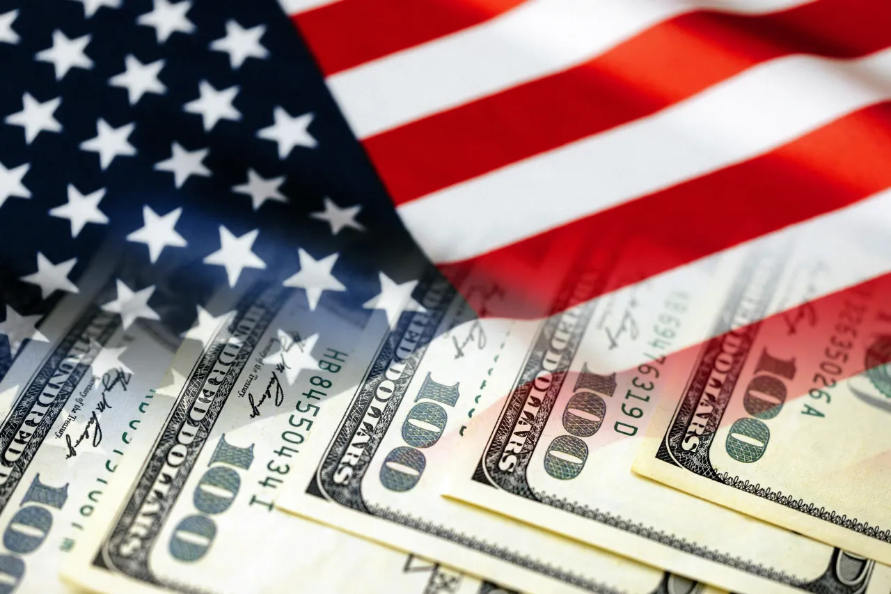 American flag and cash dollar bills - Economics chart (USA, money, economy, inflation, elections, tariffs, government (Photo Courtesy of Javier Ghersi via Getty Images)