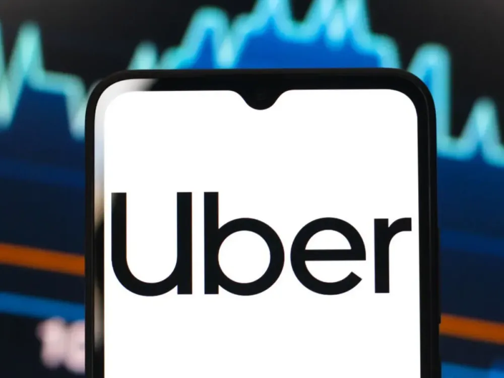 In this photo illustration, the Uber Technologies logo is seen displayed on a smartphone screen. (Photo Illustration by Thomas Fuller/SOPA Images/LightRocket via Getty Images)