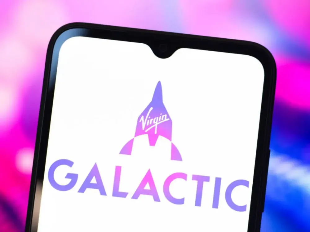 In this photo illustration, the Virgin Galactic logo is seen displayed on a smartphone screen. (Photo Illustration by Thomas Fuller/SOPA Images/LightRocket via Getty Images)