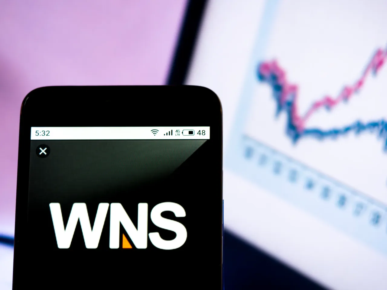 n this photo illustration a WNS Global Service - World Network Services logo seen displayed on a smartphone. 