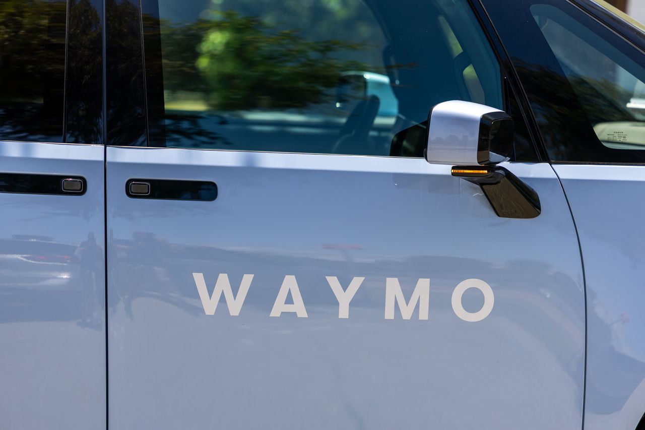 GERMANY - 2026/03/04: In this photo illustration, the logo of US autonomous driving company Waymo LLC is displayed on a smartphone in front of abstract background on computer screen. (Photo Illustration by Timon Schneider/SOPA Images/LightRocket via Getty Images)