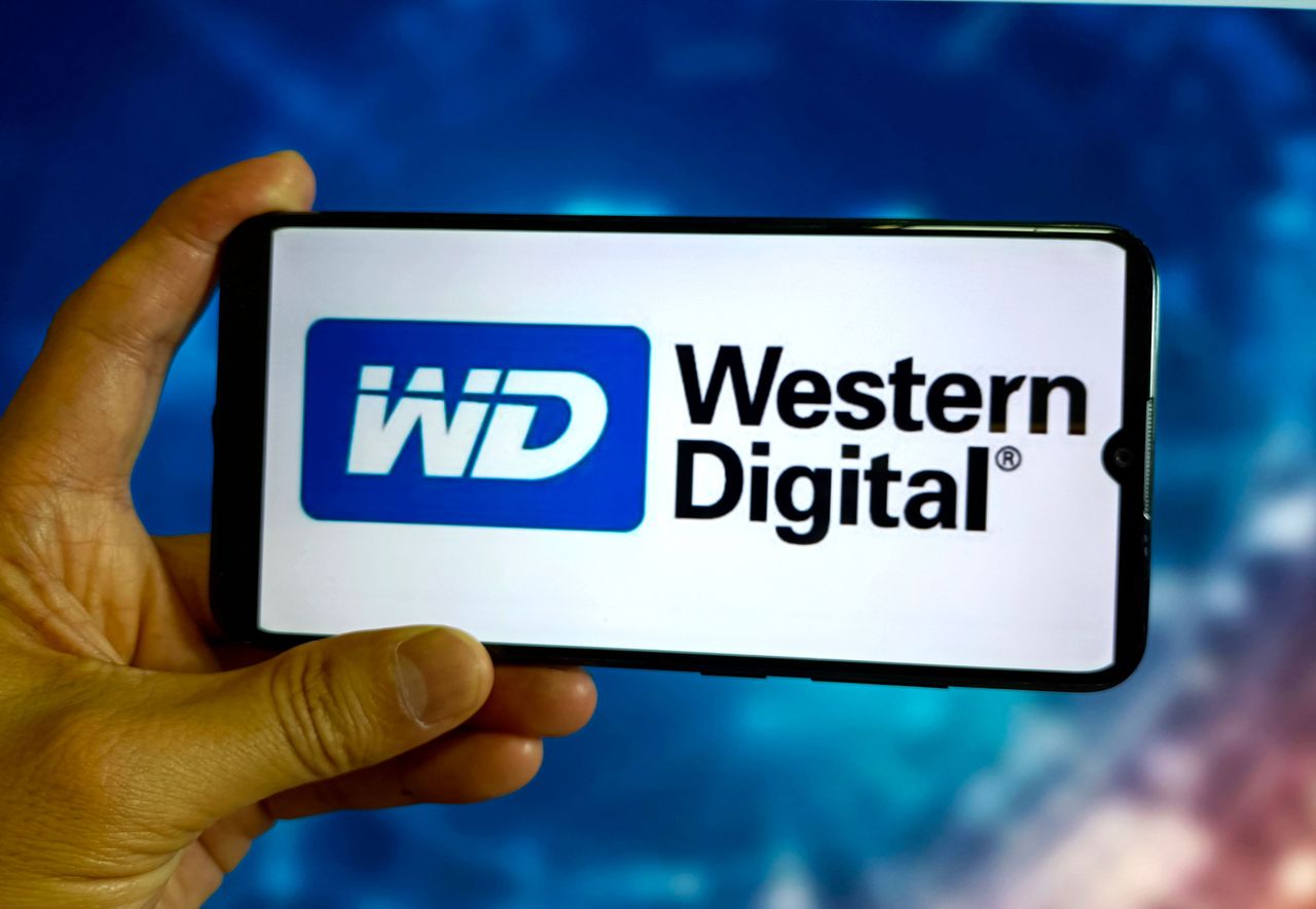 A person holds a smartphone displaying the Western Digital logo. (Photo credit should read CFOTO/Future Publishing via Getty Images)