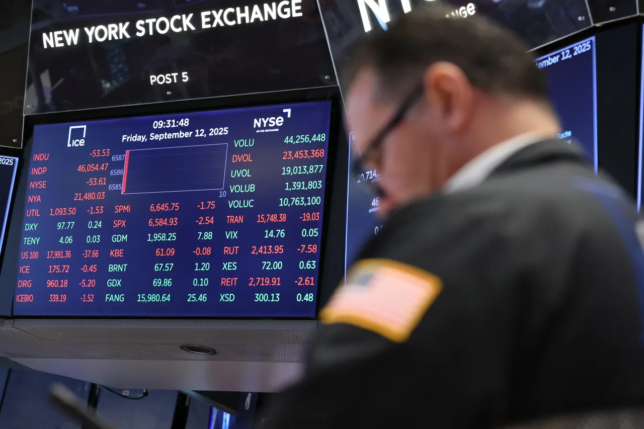 Stock market numbers are displayed as traders work on the floor of the New York Stock Exchange during morning trading. (Photo by Michael M. Santiago/Getty Images)