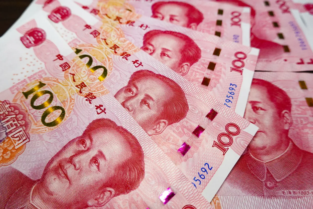 In this photo illustration, a row of 100 - yuan Renminbi banknotes is displayed. 