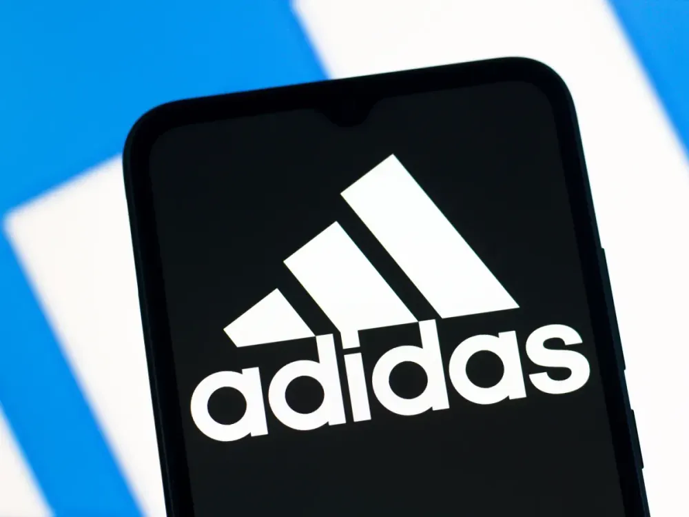 In this photo illustration, the Adidas logo is seen displayed on a smartphone screen. (Photo Illustration by Thomas Fuller/SOPA Images/LightRocket via Getty Images)