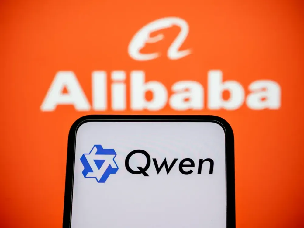 Qwen generative AI logo displayed on a cell phone, with the Alibaba company logo in the background. (Photo by Samuel Boivin/NurPhoto via Getty Images)