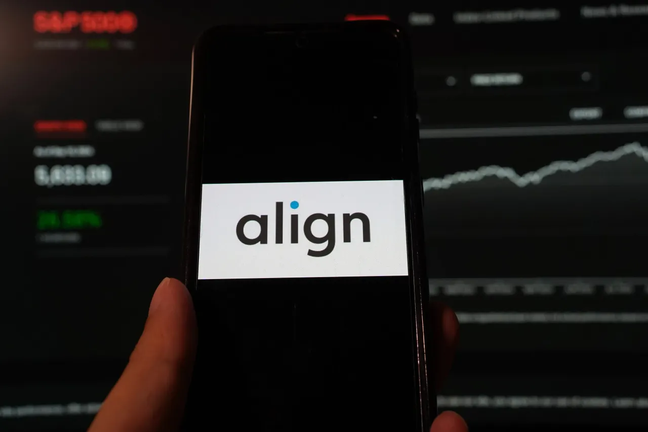 In this photo illustration, Align Technology logo is displayed on a smartphone with a S&P index website background. (Photo Illustration by Alvin Chan/SOPA Images/LightRocket via Getty Images)
