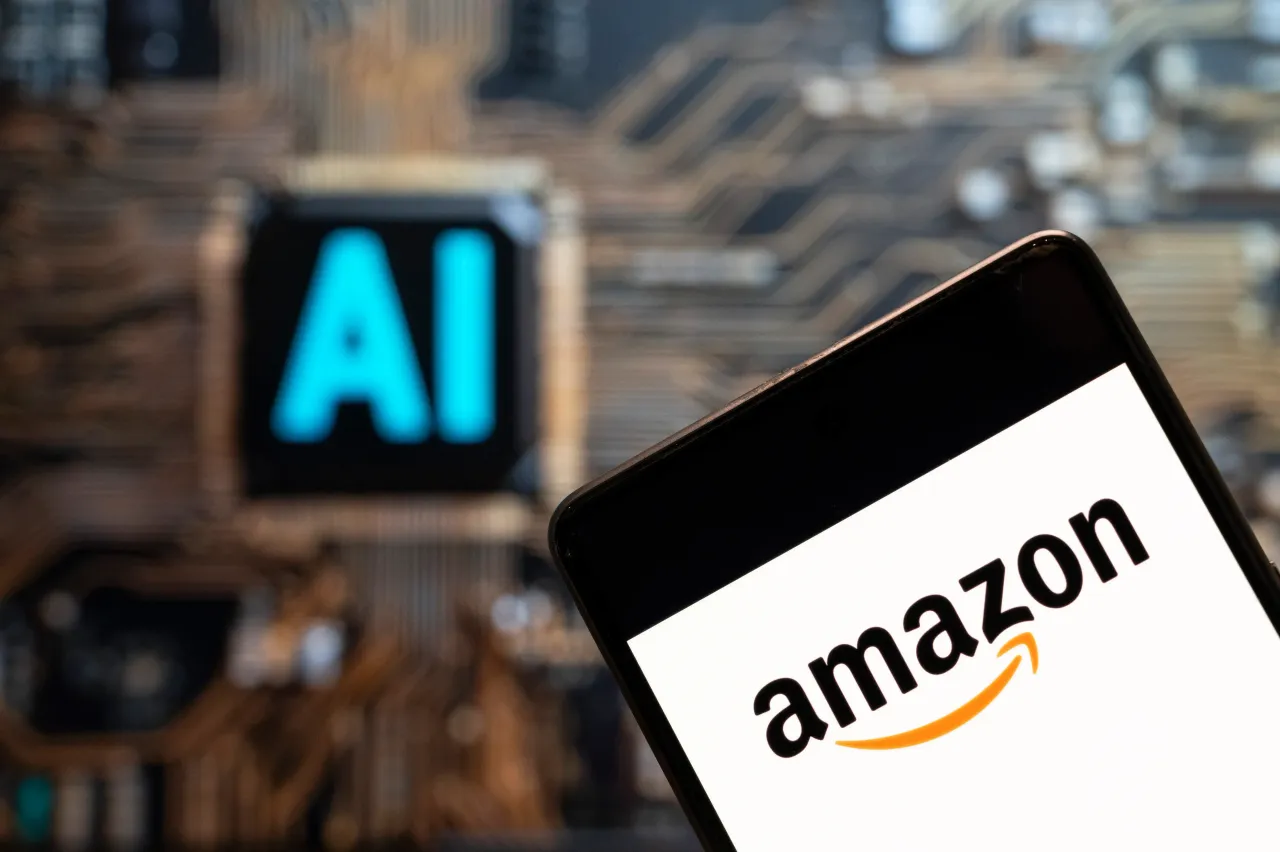 In this photo illustration, the Amazon logo is seen displayed on a smartphone with an Artificial intelligence (AI) chip and symbol in the background. (Photo Illustration by Budrul Chukrut/SOPA Images/LightRocket via Getty Images)