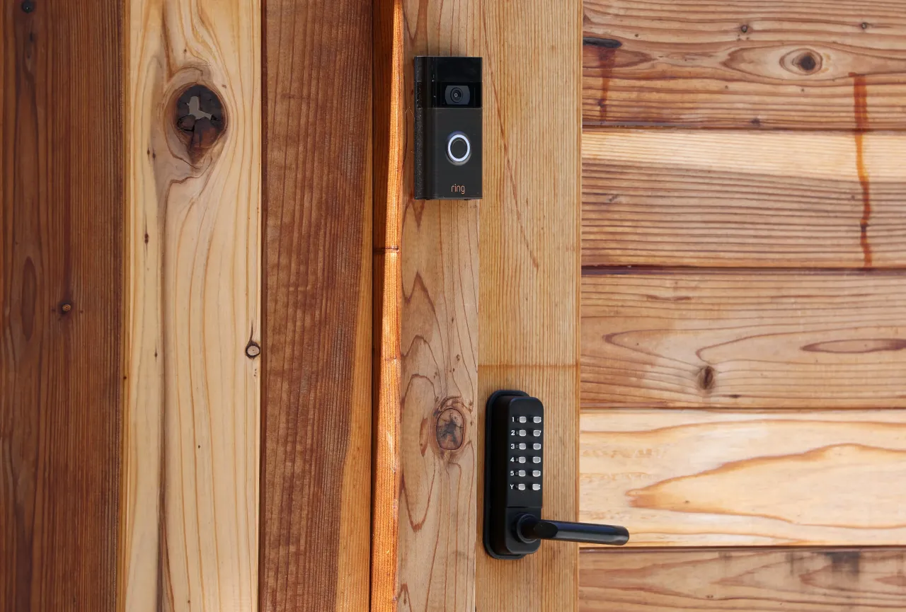 A Ring security camera is seen on the fence of a home