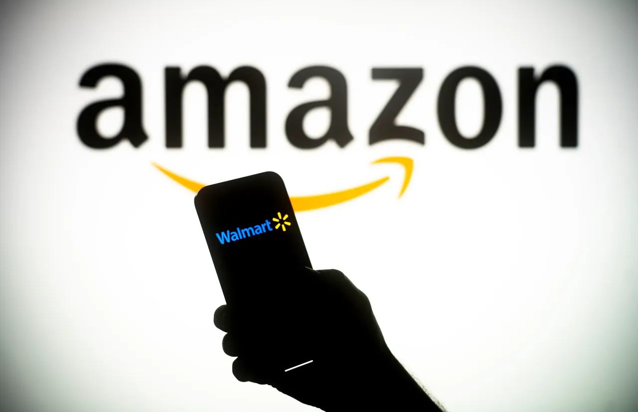 The Amazon and Walmart logos are seen on in this illustration photo