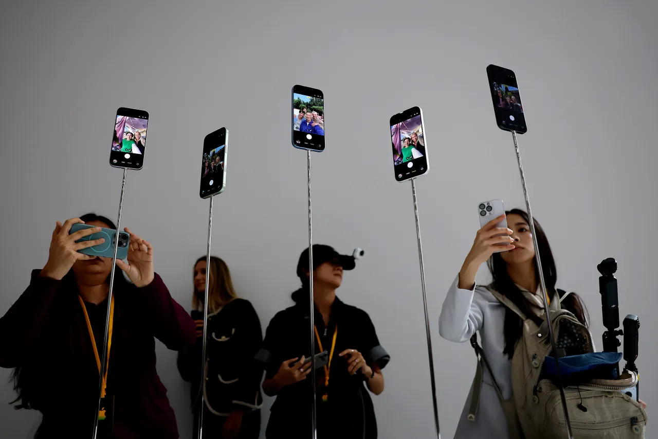 Attendees take pictures of the next generation iPhone 17 during an Apple special event at Apple headquarters on September 9, 2025 in Cupertino, California