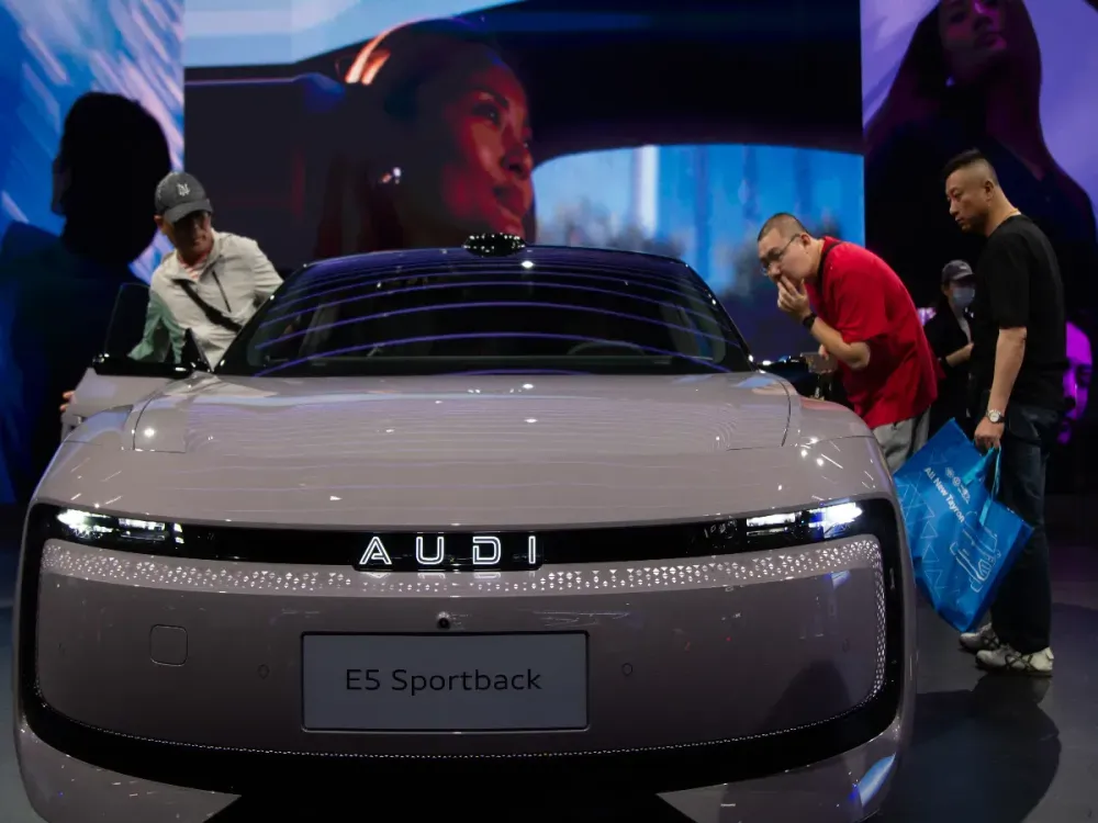 An Audi E5 Sportback car is seen at the Audi booth in the National Exhibition Center in Shanghai, China, on April 28, 2025, during the Shanghai Automobile Show 2025. (Photo by Ying Tang/NurPhoto via Getty Images)