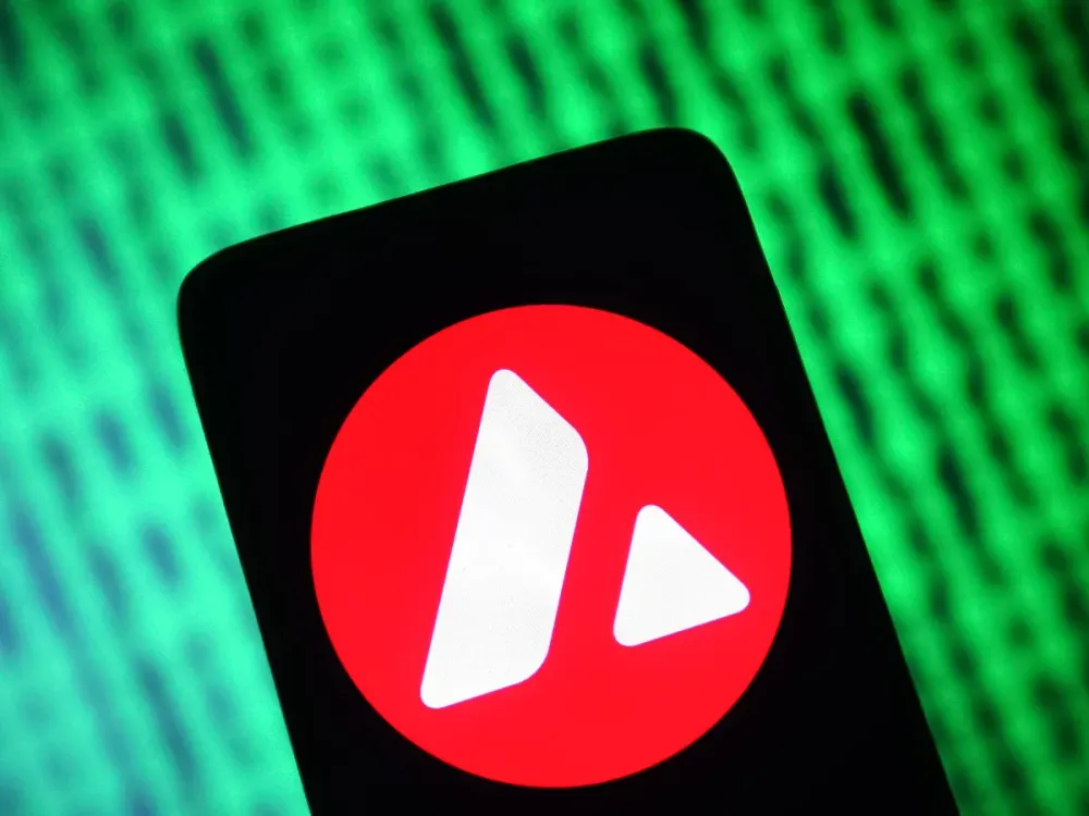 In this photo illustration, an Avalanche (AVAX) crypto token sign is seen on a smartphone and a computer screen. (Photo Illustration by Pavlo Gonchar/SOPA Images/LightRocket via Getty Images)