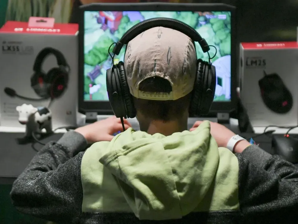 12 April 2019, Berlin: A child plays a computer game with headphones on his ears at the Gamefest in the Kulturbrauerei as part of Gamesweekberlin 2019.(Photo by Jens Kalaene/picture alliance via Getty Images)