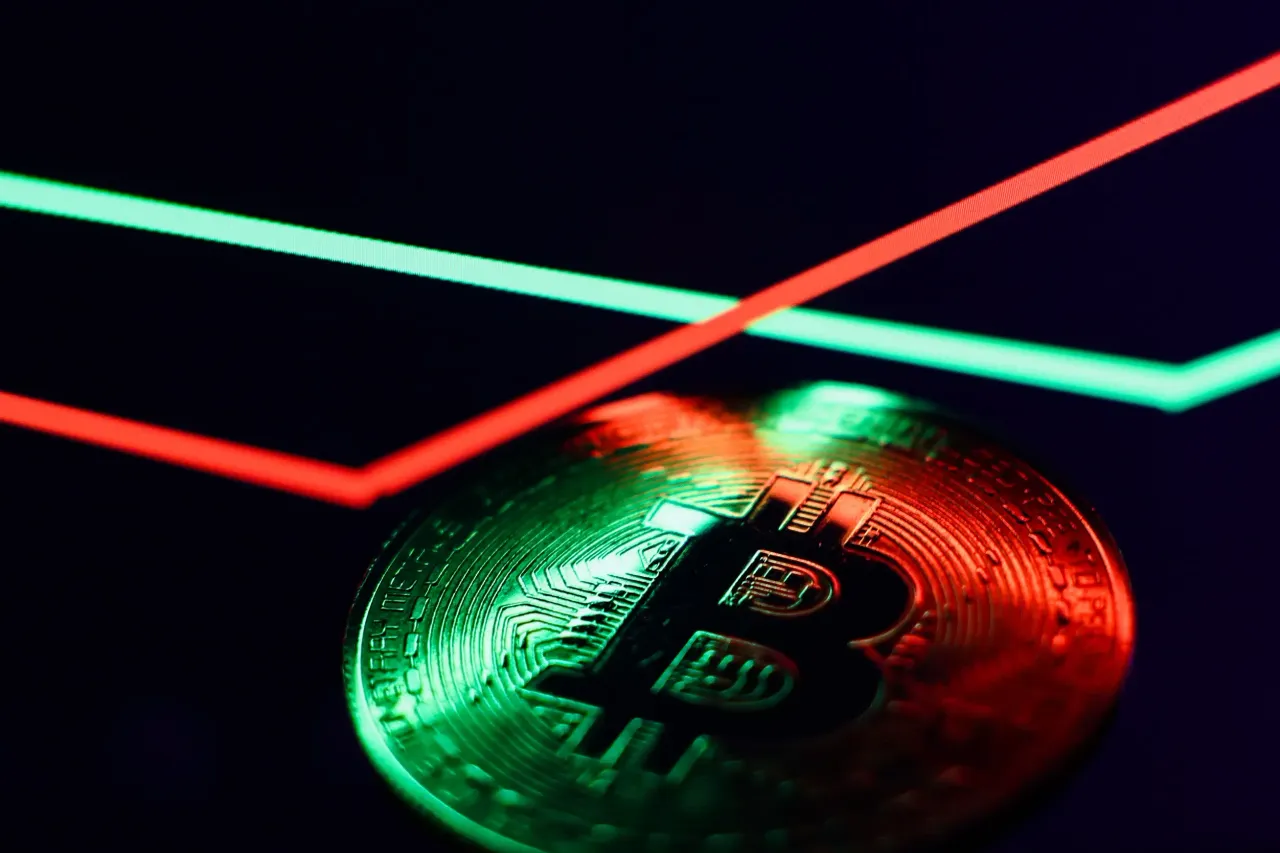 An illustrative stoc graph displayed on a laptop screen and representation of Bitcoin cryptocurrency are seen in this illustration photo taken in Krakow, Poland on February 2, 2026. (Photo by Jakub Porzycki/NurPhoto via Getty Images)