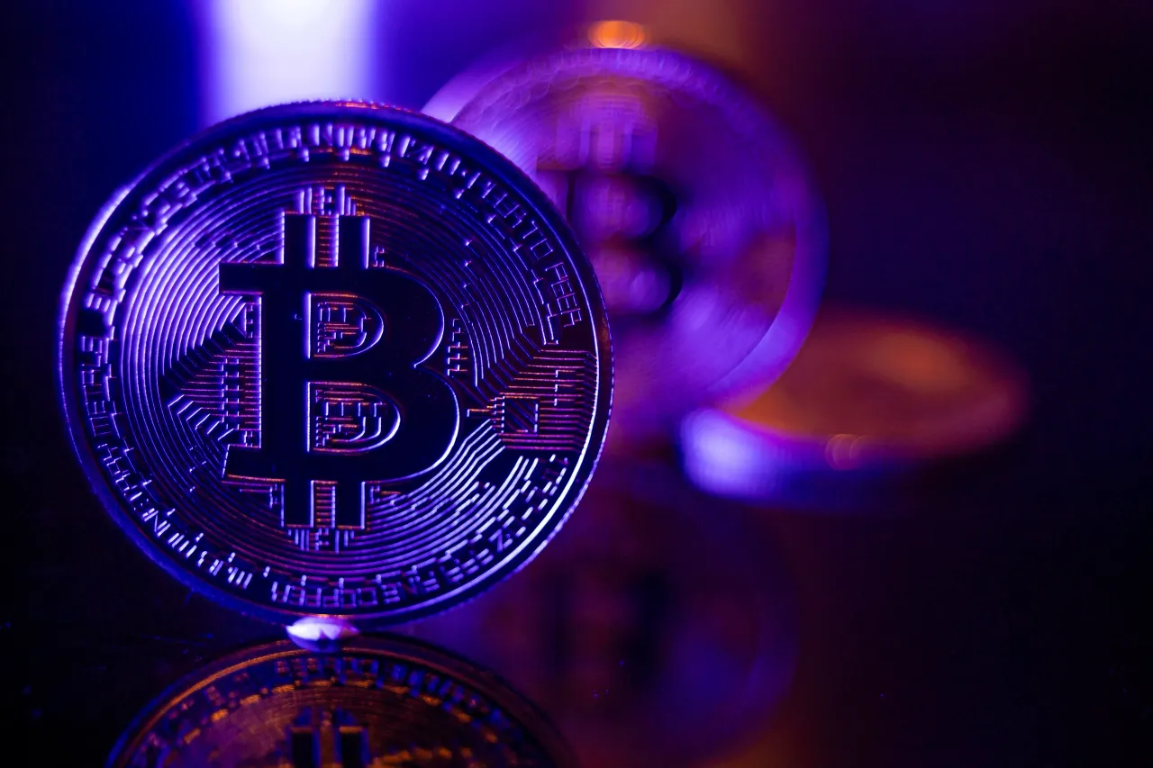 Bitcoins golden physical coin illustration on dark black background with reflection and vibrant color light illumination. Amsterdam, the Netherlands on March 10, 2024 (Photo by Nicolas Economou/NurPhoto via Getty Images)