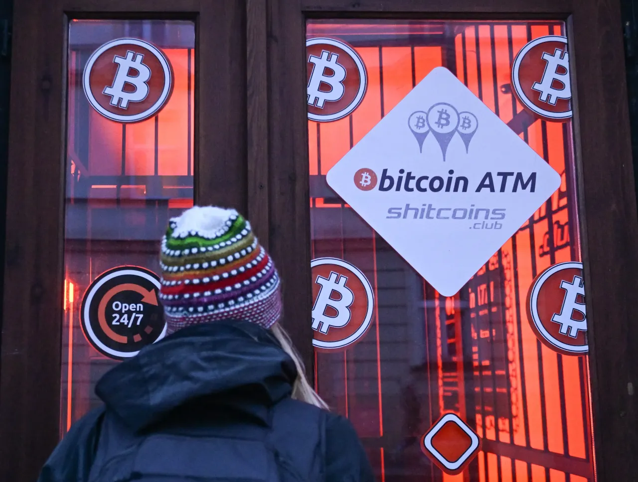 A woman checking the latest Bitcoin prices through the window of a Bitcoin ATM, on December 16, 2024, in Rzeszow, Subcarpathian Voivodeship, Poland. (Photo by Artur Widak/NurPhoto via Getty Images)