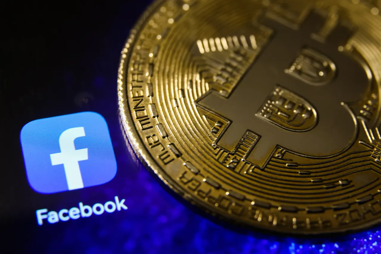 Bitcoin cryptocurrency physical representation is photographed with Facebook logo for illustration photo in Krakow, Poland on May 4, 2023. (Photo by Beata Zawrzel/NurPhoto via Getty Images)