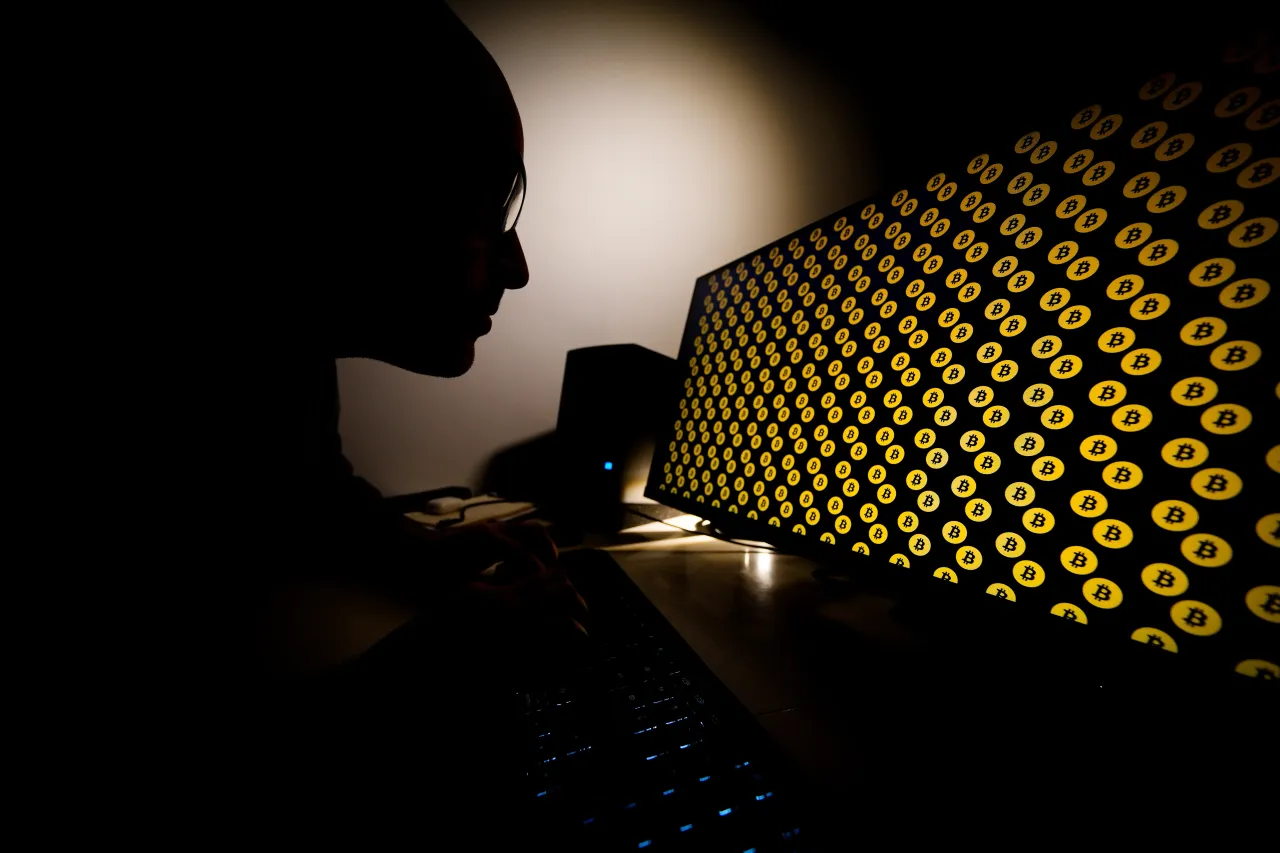 A man is seen uses a computer with Bitcoin logos on a screen in Warsaw, Poland on February 21, 2021. (Photo illustration by Jaap Arriens/NurPhoto via Getty Images)