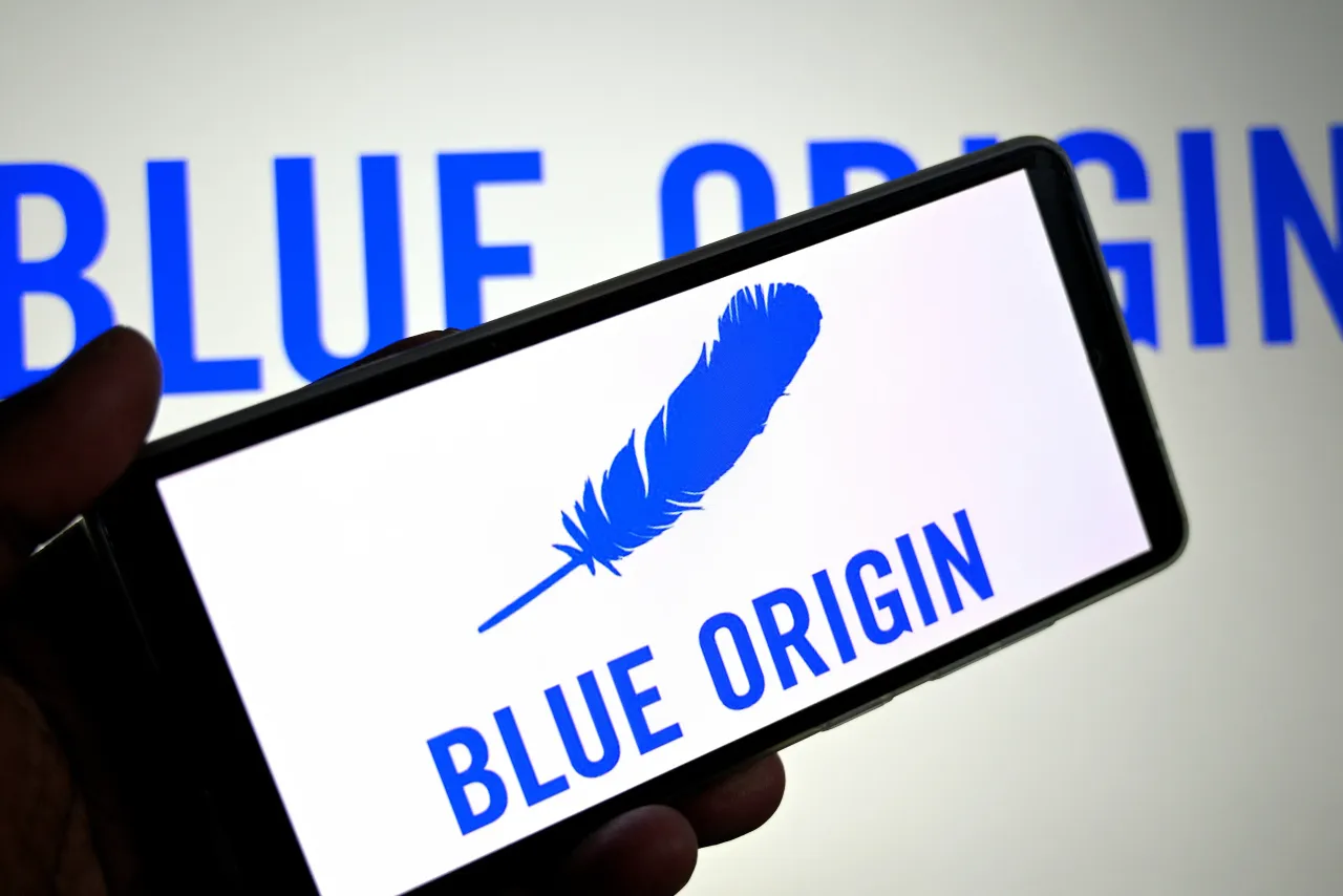 In this photo illustration, a Blue Origin logo is seen displayed on a smartphone and in the background. (Photo Illustration by Avishek Das/SOPA Images/LightRocket via Getty Images)