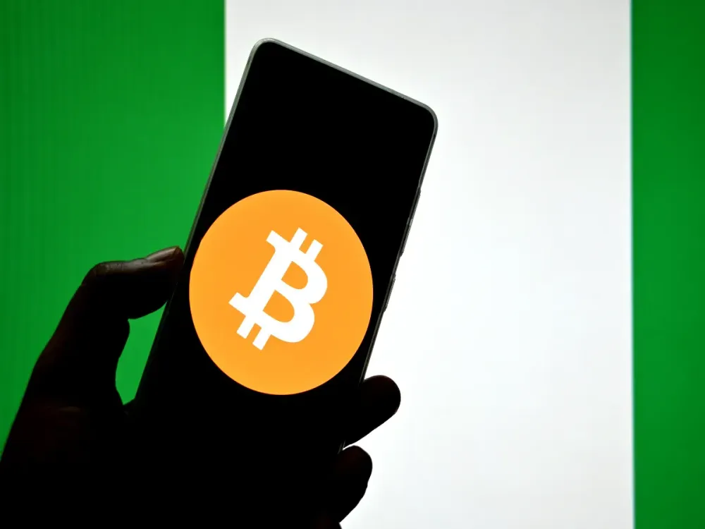 In this photo illustration, a Bitcoin logo is seen displayed on a smartphone with the Nigerian flag in the background. (Photo Illustration by Avishek Das/SOPA Images/LightRocket via Getty Images)