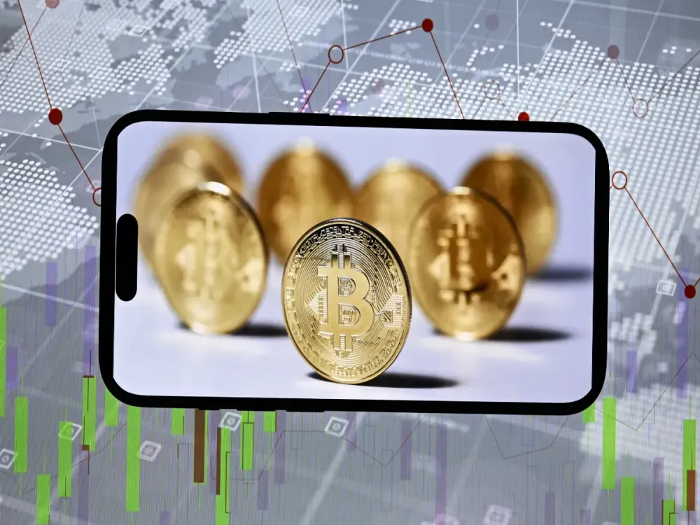 In this photo illustration 'Bitcoin' coins are displayed on a smartphone in Ankara, Turkiye on January 02, 2024. (Photo by Ismail Kaplan/Anadolu via Getty Images)