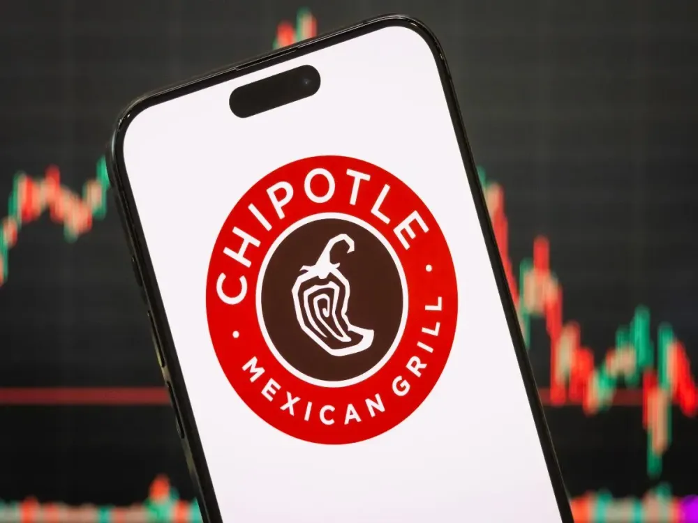 n this photo illustration, the logo of Chipotle Mexican Grill, Inc. is displayed on a smartphone screen, with the company's stock market chart in the background, on April 20, 2025, in Chongqing, China. (Photo illustration by Cheng Xin/Getty Images)