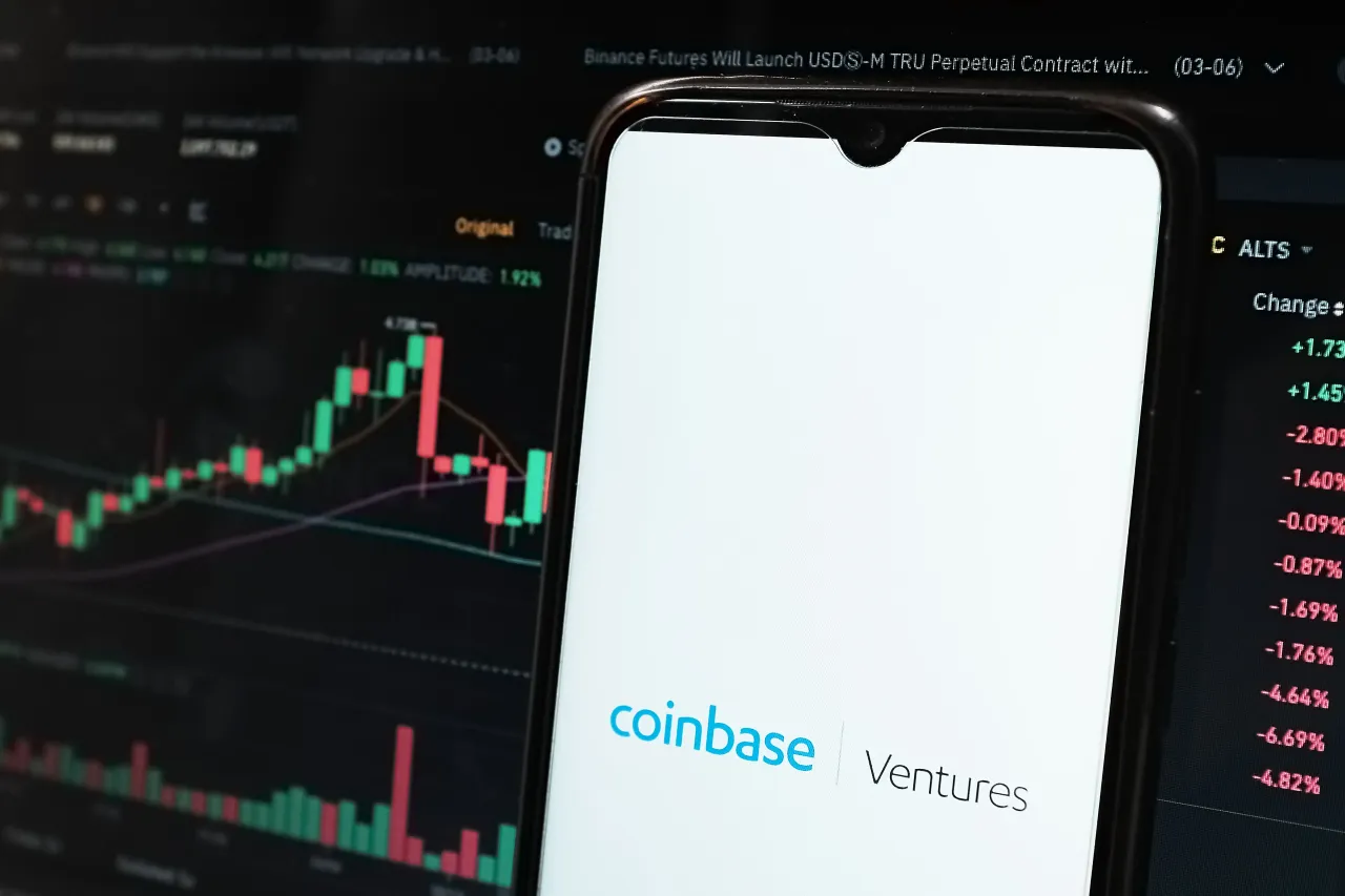 In this photo illustration a Coinbase Ventures logo seen displayed on a smartphone screen and an exchange graph in Athens, Greece on June 5, 2023. (Photo by Nikolas Kokovlis/NurPhoto via Getty Images)
